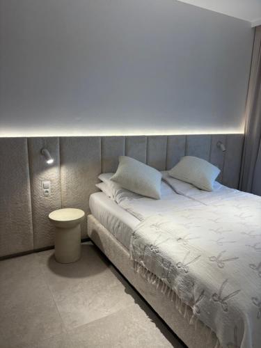 a bed with white sheets and pillows in a bedroom at Czarna Perła Hel in Hel