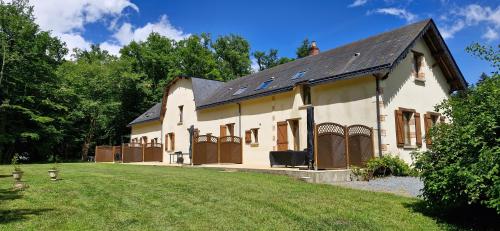 a large white house with a large yard at Gîtes du Château de Malcombe in Rillé