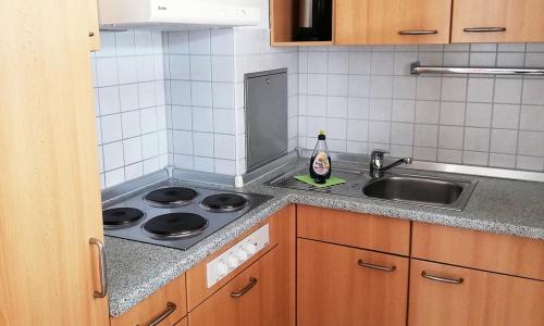 a kitchen counter with a sink and a stove at Sommerhof Rauber in Immenstaad am Bodensee