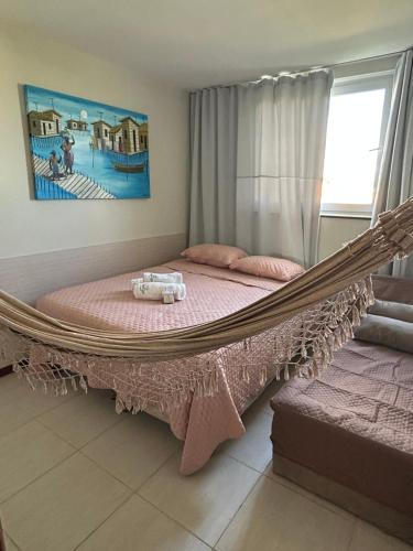 a large bed in a room with a hammock at TREE BIES RESORT, Apartamento Refúgio dos Sonhos 3 quartos, 2 suítes in Subaúma
