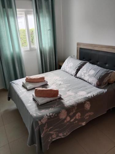 a bed with two pillows on it in a bedroom at Villa Marrajo La Torre Golf Resort in Torre-Pacheco