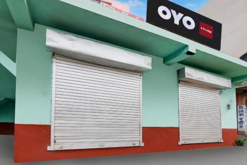 two garage doors on the side of a building at Hotel O A R Lodge in Durgāpur
