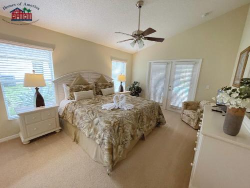 a bedroom with a bed and a ceiling fan at 35 - Relax & Play 4-Bed Villa with Pool & Game Room Minutes to Disney in Orlando