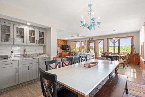 a kitchen and dining room with a table and chairs at Endless Summer in Sanderling