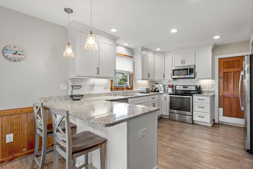 a kitchen with white cabinets and a counter top at Endless Summer in Sanderling