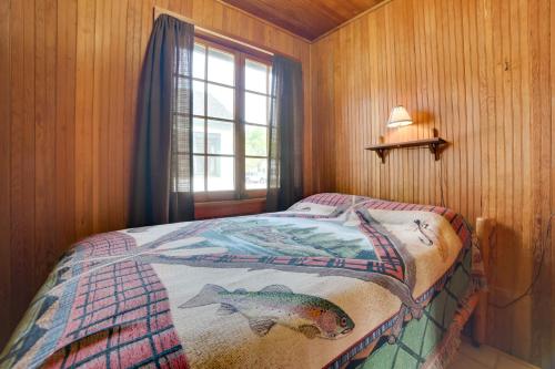 a bedroom with a bed with a fish blanket on it at Fish, Boat and Swim Cedarville Gem 6 with Dock Access in Cedarville