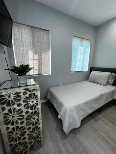 a bedroom with a bed and a window at LUXURY VILLA Estate Oasis in Downey