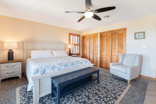 a bedroom with a bed and a chair at Endless Summer in Sanderling