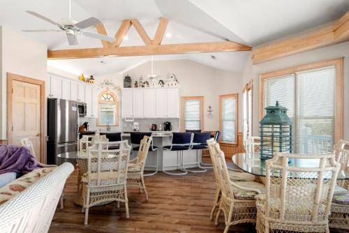 a kitchen and dining room with a table and chairs at Fergusons Flagship in Nags Head