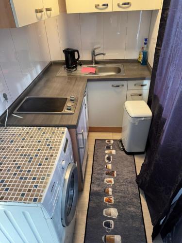 a small kitchen with a washing machine and a sink at Retals Stuttgart City3 in Stuttgart