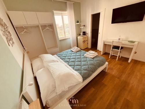 a small bedroom with a bed and a desk at Villa Marelago Guest House in Lido Di Fondi