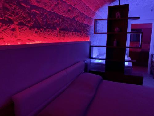 a living room with a couch and red lighting at Agape B&B Monopoli in Monopoli