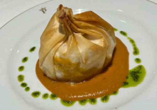 a white plate with a dessert with sauce on it at Parador de Ceuta in Ceuta