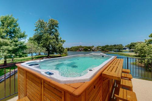 a hot tub on a deck with a view of a lake at Paradise Cove in Granite Shoals