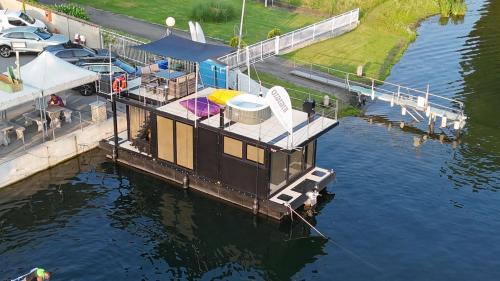 a boat is docked at a dock in the water at DIAMOND Bigigio House Boat in Lisanza