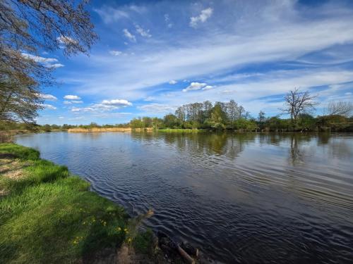 a view of a river on a cloudy day at ChillForest SPA in Tomczyn