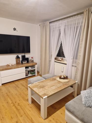 a living room with a table and a large window at Agroturystyka u Agnieszki - Mazury 
