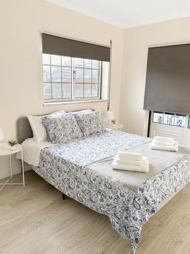 a bedroom with a large bed with two towels on it at GoldMar Beach Apartments - Praia da Vieira in Vieira de Leiria