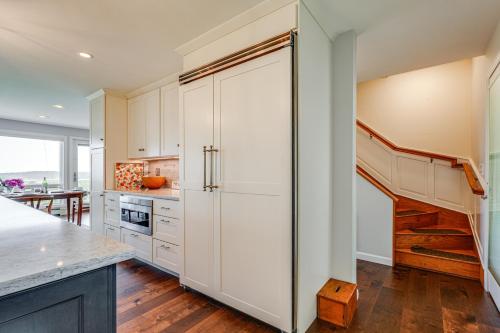 a kitchen with white cabinets and a refrigerator at Kennebec River Retreat Less Than 5 Mi to Popham Beach in Phippsburg