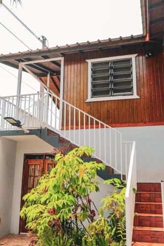 a house with a staircase leading up to a window at Mayagüez Apartment in Mayaguez