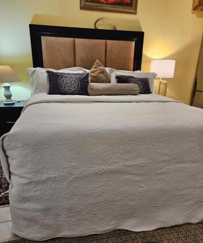a bedroom with a large white bed with pillows at RPG Corporate Unit in Johannesburg