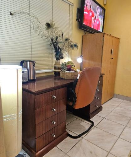 a wooden desk with a chair in a room at RPG Corporate Unit in Johannesburg