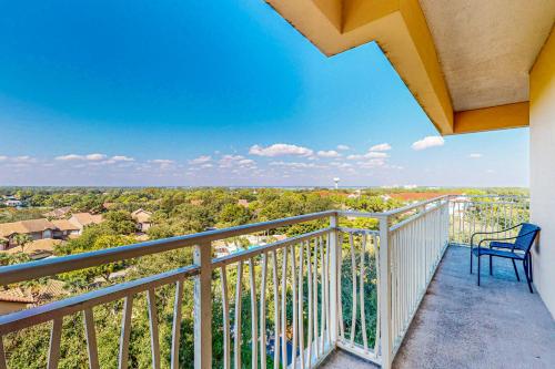 a balcony with a chair and a view at Luau I 6710 in Destin