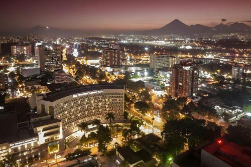 a view of a city at night with lights at The Westin Camino Real, Guatemala in Guatemala