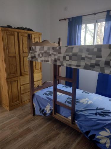 a bunk bed in a room with a wooden floor at Mi lugar en el mundo in Cortaderas