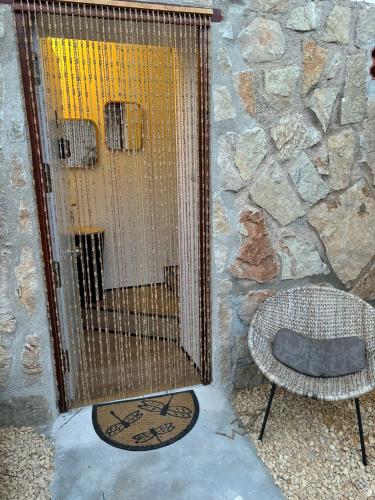 a bird cage sitting next to a stone wall at Casa Halcón in Jávea