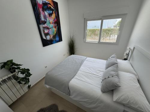 a white bed in a bedroom with a window at Villa Ohana - A Murcia Holiday Rentals Property in Roldán