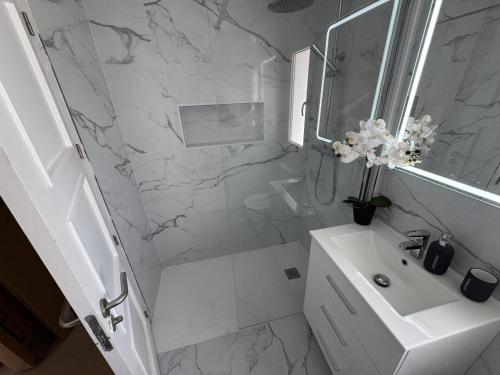 a white bathroom with a sink and a mirror at Villa Ohana - A Murcia Holiday Rentals Property in Roldán