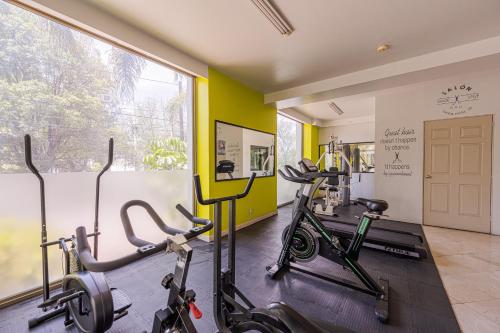 a gym with three exercise bikes in a room at HG Hotel in Guadalajara