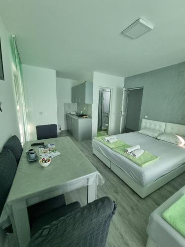 a room with a bed and a table and a couch at Bovan GREEN LAKE apartments in Soko Banja