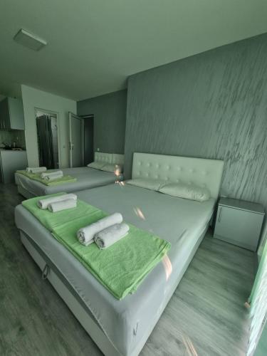a rendering of a bedroom with two beds with towels at Bovan GREEN LAKE apartments in Soko Banja