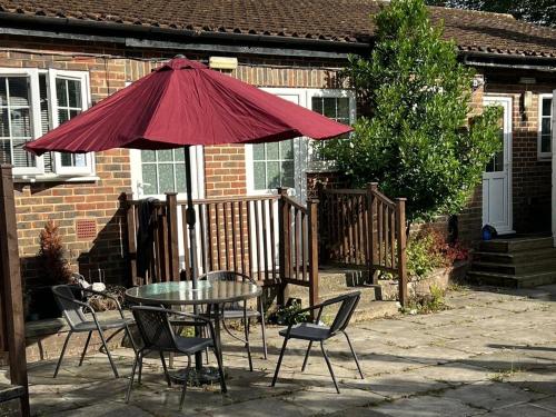 a patio with a table and chairs and an umbrella at Griffin Chalets in Southampton