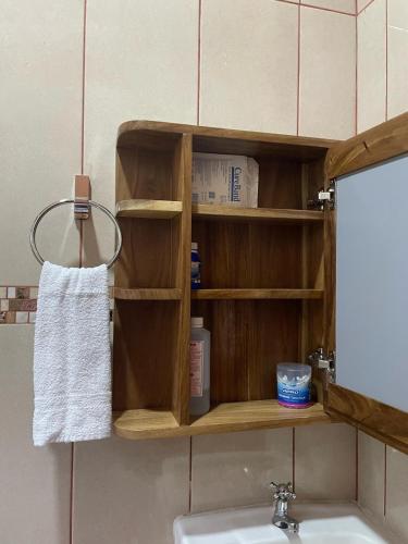 a wooden shelf above a sink in a bathroom at Fergust Family Studio Monteverde in Sierra