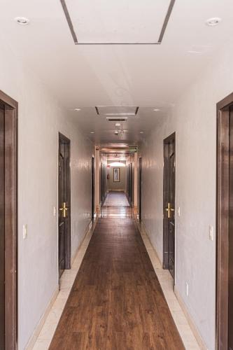 an empty hallway with wood floors and a ceiling at HG Hotel in Guadalajara