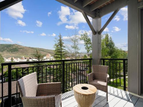 a patio with chairs and a table on a balcony at Crestview Condominiums by All Seasons Resort Lodging in Park City