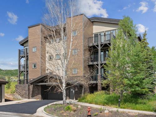 a building with a tree in front of it at Crestview Condominiums by All Seasons Resort Lodging in Park City