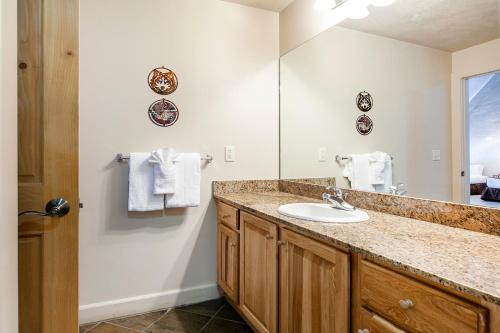 a bathroom with a sink and a mirror at Crestview Condominiums by All Seasons Resort Lodging in Park City