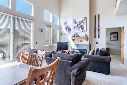 a living room with a couch and a table at Crestview Condominiums by All Seasons Resort Lodging in Park City
