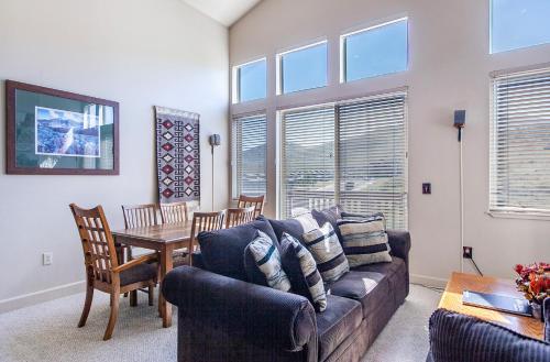 a living room with a couch and a table at Crestview Condominiums by All Seasons Resort Lodging in Park City