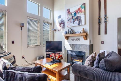 a living room with a couch and a fireplace at Crestview Condominiums by All Seasons Resort Lodging in Park City
