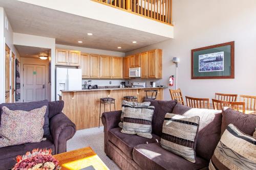 a living room with two couches and a kitchen at Crestview Condominiums by All Seasons Resort Lodging in Park City