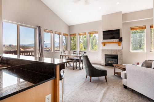 a living room with a table and a fireplace at Crestview Condominiums by All Seasons Resort Lodging in Park City
