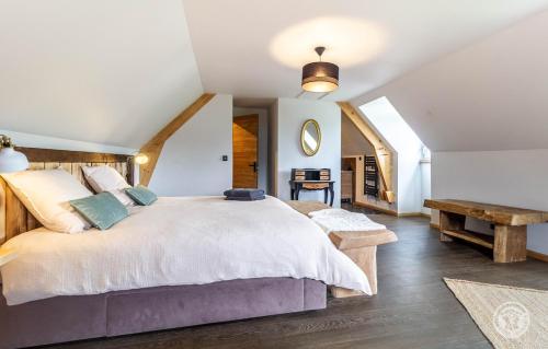 a bedroom with a large bed and a table at Villa Malinat entre Val d'Azun et Vallée des Gaves in Arcizans-Avant