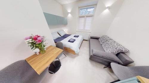 a living room with a couch and a table at Apartments Štěpánská Brno-centre in Brno