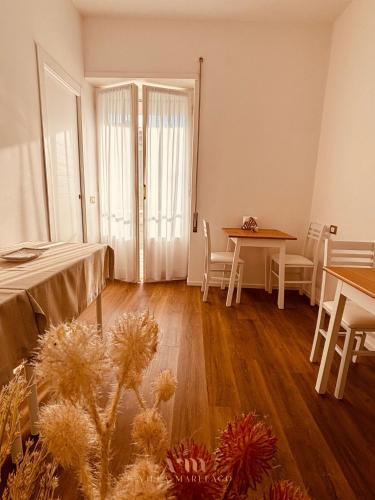a room with a table and a table and chairs at Villa Marelago Guest House in Lido Di Fondi