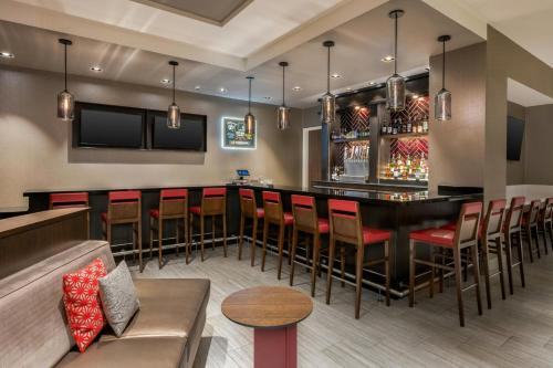 a bar in a restaurant with chairs and a couch at Springhill Suites By Marriott Athens Downtown/University Area in Athens